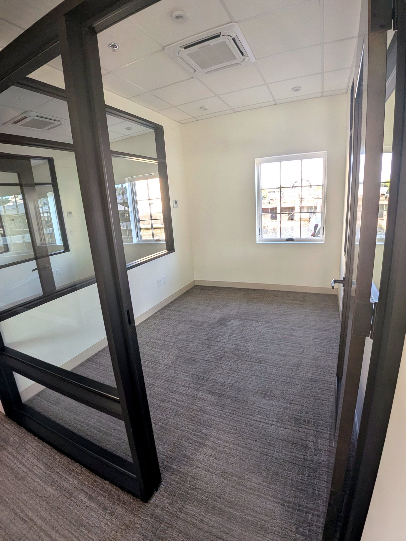 Glass-front private office with water view